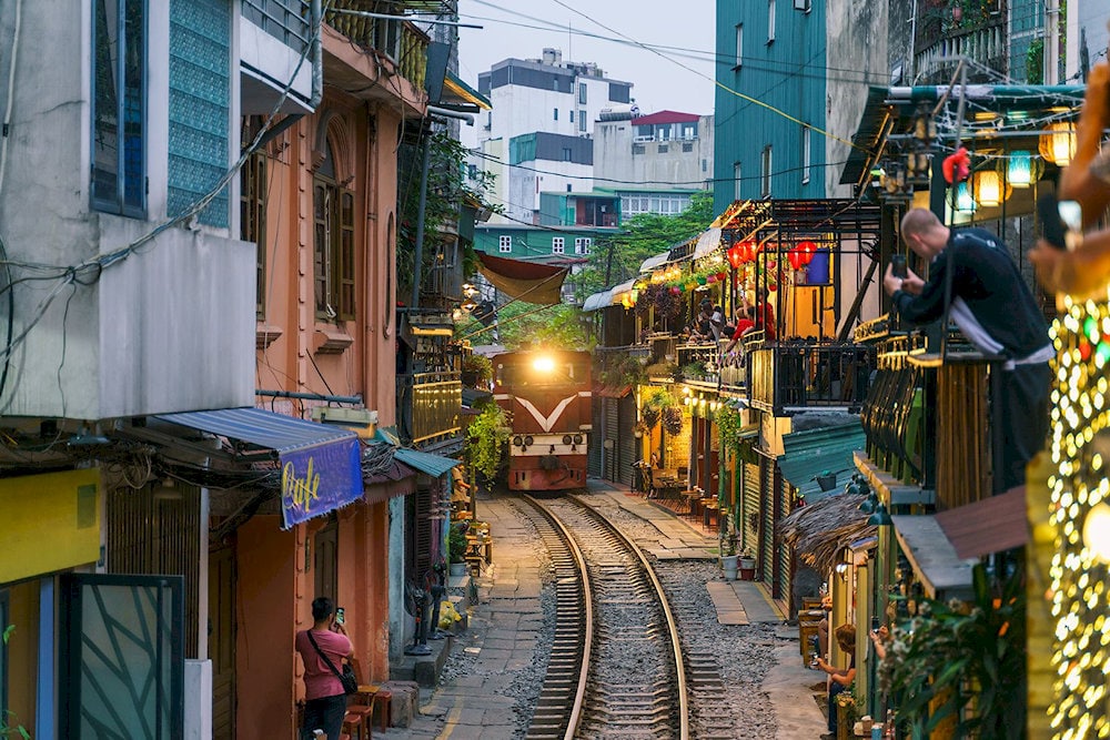 Train Street offers a one-of-a-kind thrill as visitors enjoy coffee mere steps away from roaring trains passing by
